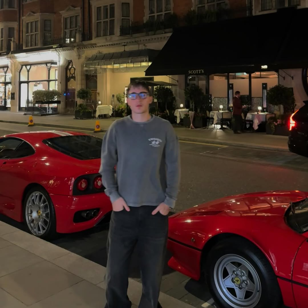 Standing between two red Ferraris outside Scott's, London